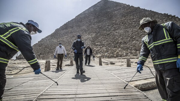 Los trabajadores del municipio egipcio desinfectan la necrópolis de las pirámides de Giza, en las afueras del suroeste de la capital egipcia, El Cairo, el 25 de marzo de 2020 como medida de protección contra la propagación del coronavirus.