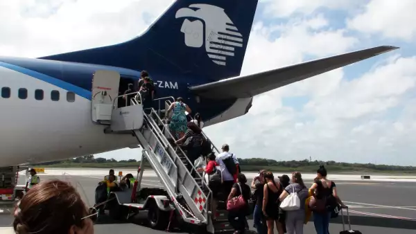 Aeromexico Passengers On Airstair Queuing In Line To Board Airplane At Cancun International Airport Mexico