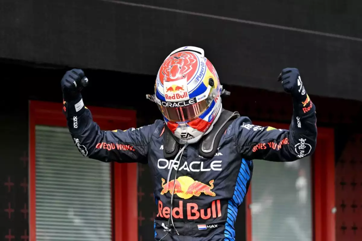 foto de max verstappen levantando los brazos y con el casco puesto tras ganar el primer lugar en la f1 imola 2024