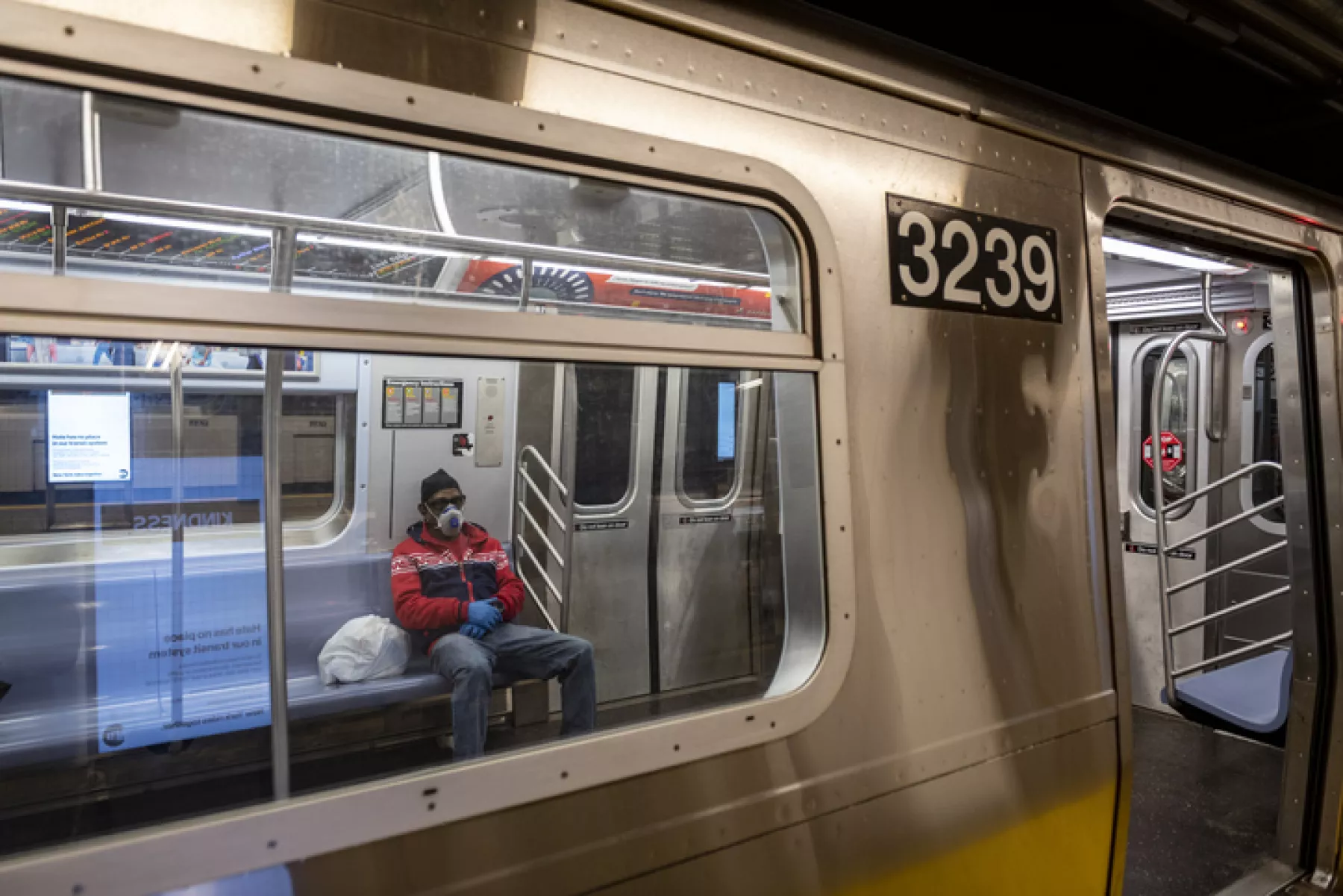 Subway commuter wearing respirator mask in New York City