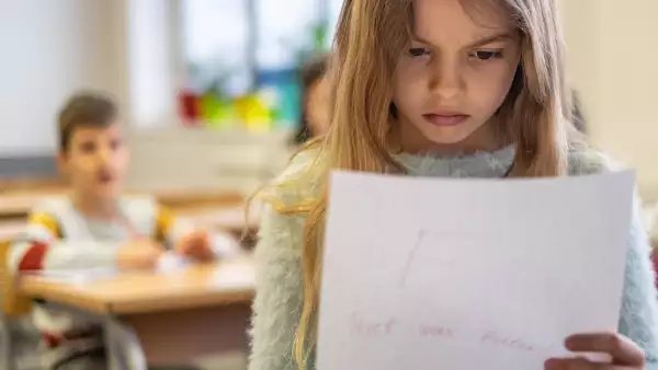 Beautiful schoolgirl is sad because bad grade
