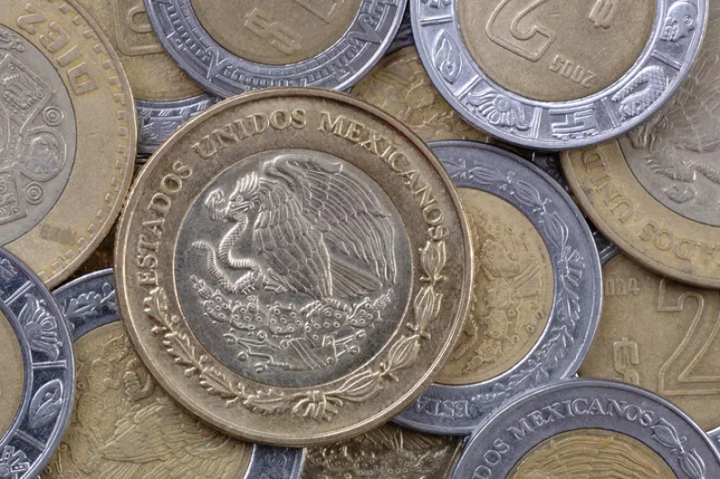Close-up of various, shiny Mexican peso coins