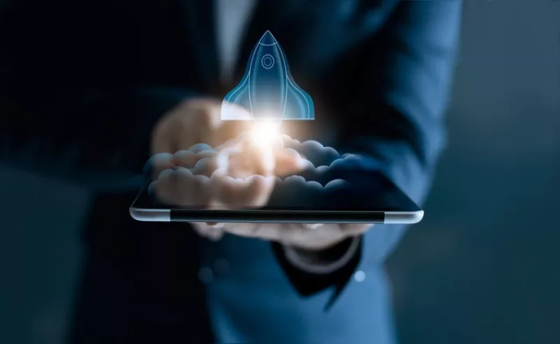 Startup concept, transparent rocket is launching and flying out of tablet on screen