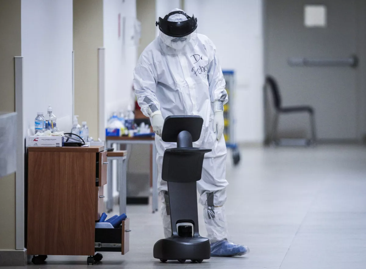 A healthcare worker uses a robot to carry out consultations with patients suffering from the coronavirus disease COVID-19, at NOVA hospital in Monterrey