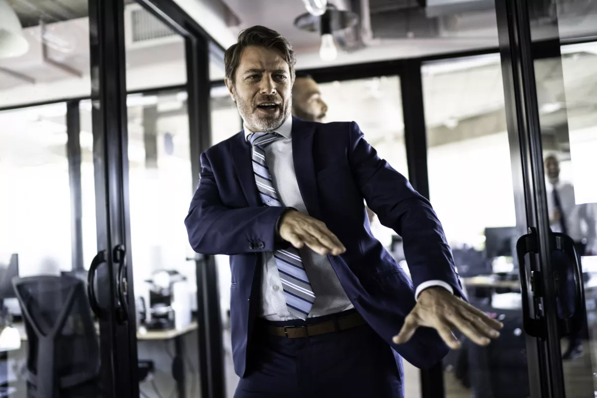 Coworkers walking and dancing around the office