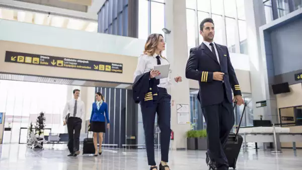 Pilots and flight attendants walking at the airport