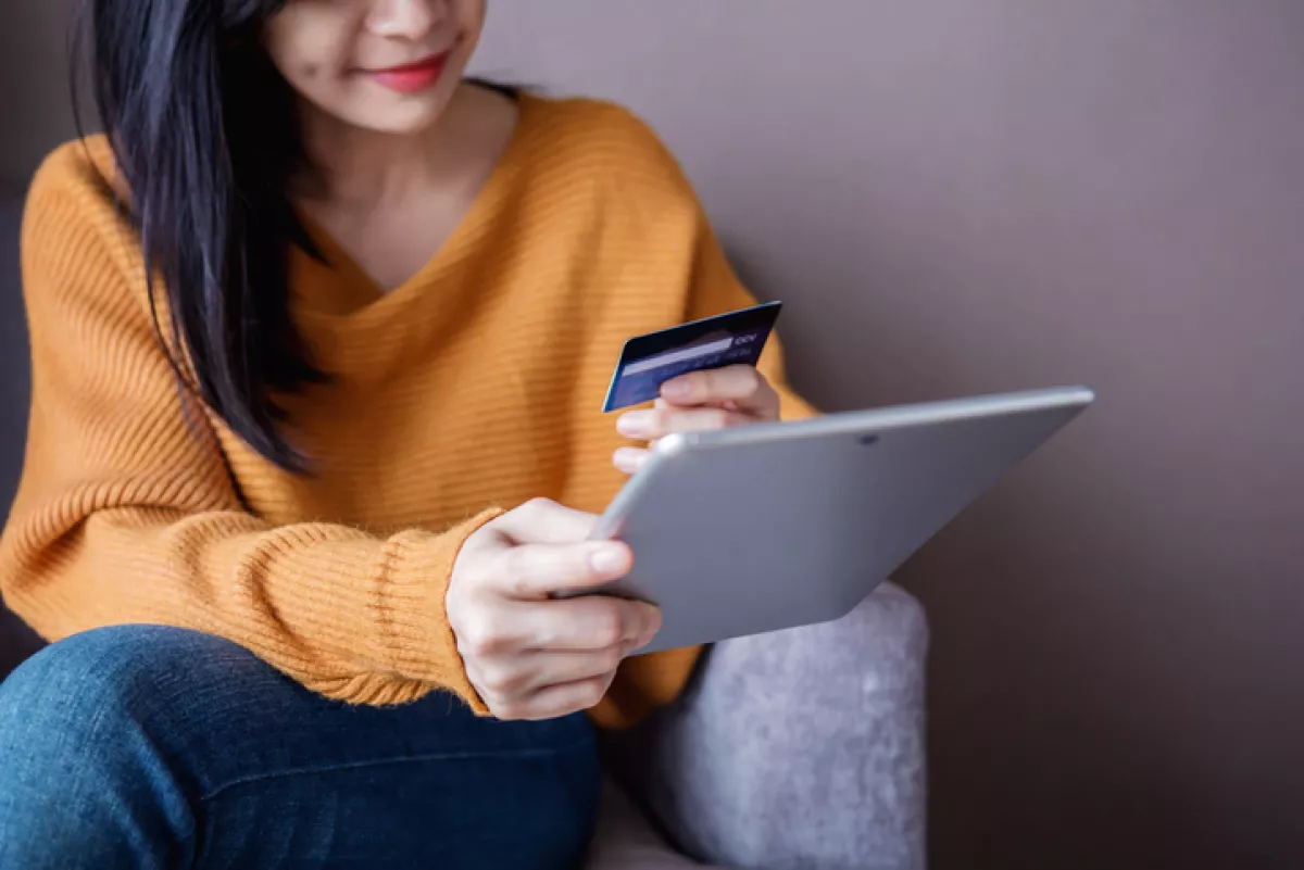 Happy Woman Customer using Credit Card and Tablet to Shopping Online. Selective focus