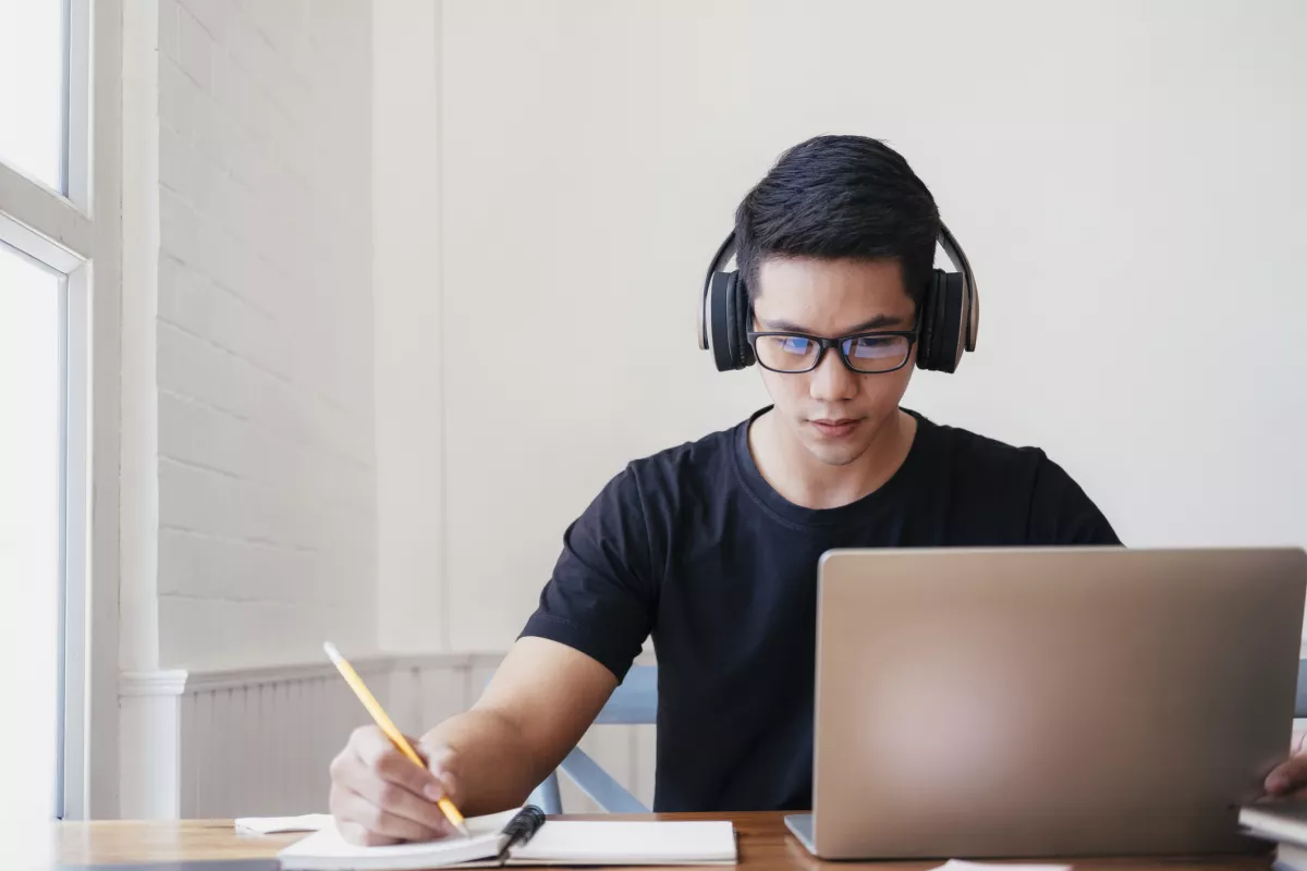 Young man student study at home using laptop and learning online.