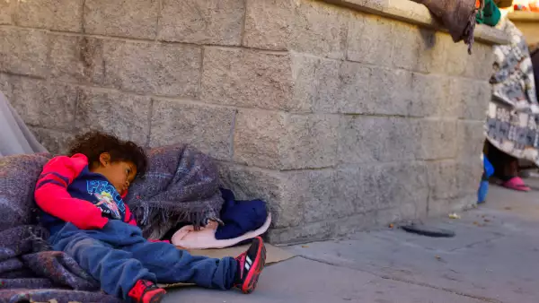 A child rests outside the migrant detention center where several migrants died after a fire broke out late on Monday, in Ciudad Juarez