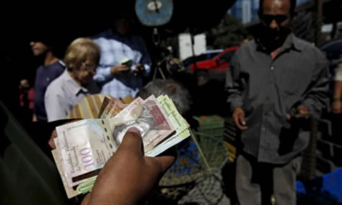 Un hombre cuenta bolívares en un mercado de vegetales en Caracas, capital de Venezuela. (Foto: Reuters )