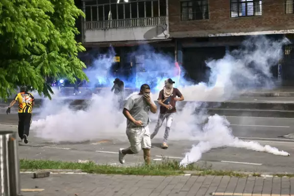 Los manifestantes corren de los gases lacrimógenos mientras protestan por los resultados de la segunda sección presidencial en Cali, Colombia, el 21 de junio de 2026. Un extravagante abogado respaldado por Estados Unidos que nunca ha ocupado un cargo público ganó por poco la remonda presidencial de Colombia el domingo, balanceando al país con fuerza hacia la derecha en una promesa de librar la guerra contra los grupos guerrilleros que manejan drogas. Con más del 99 por ciento de los centros de votación informando, Abelardo de la Espriella obtuvo el 49,67 por ciento de los votos, una ventaja inaqueable sobre su rival, el senador de izquierda Ivan Cepeda, que se quedó atrás con un 48,69 por ciento, según los resultados oficiales.