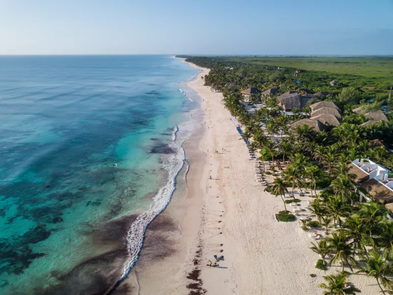 Top view aerial photo from flying drone of an amazingly beautiful sea landscape. Sea Aerial view, Top view. Tulum Beach, Mexico. Sea Aerial view. Amazing nature background. The color of the water and beautifully bright. Azure beach.