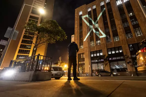 Twitter’s new logo is seen projected on the corporate headquarters building in downtown San Francisco, California