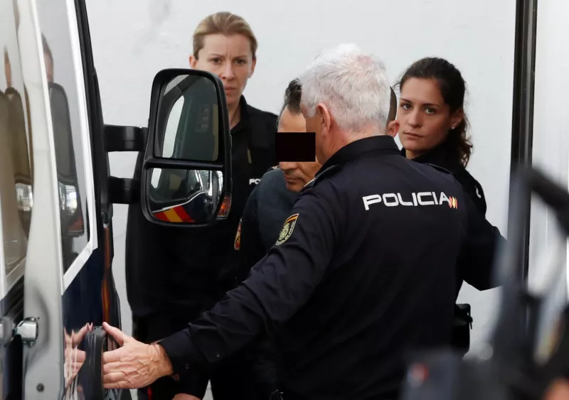 Former chief executive of Mexico's state oil firm Pemex, Emilio Lozoya, is escorted by Spanish police officers as he leaves a court after appeared in Spain's High Court via video conference after his detention in southern Spain on Wednesday, in Marbella,
