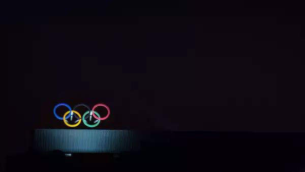 Olympic symbol (also known as Olympic Rings) seen on the Montreal olympic Committee building lit during a dark night. Montreal became an olympic city with the 1976 Summer Olympic Games