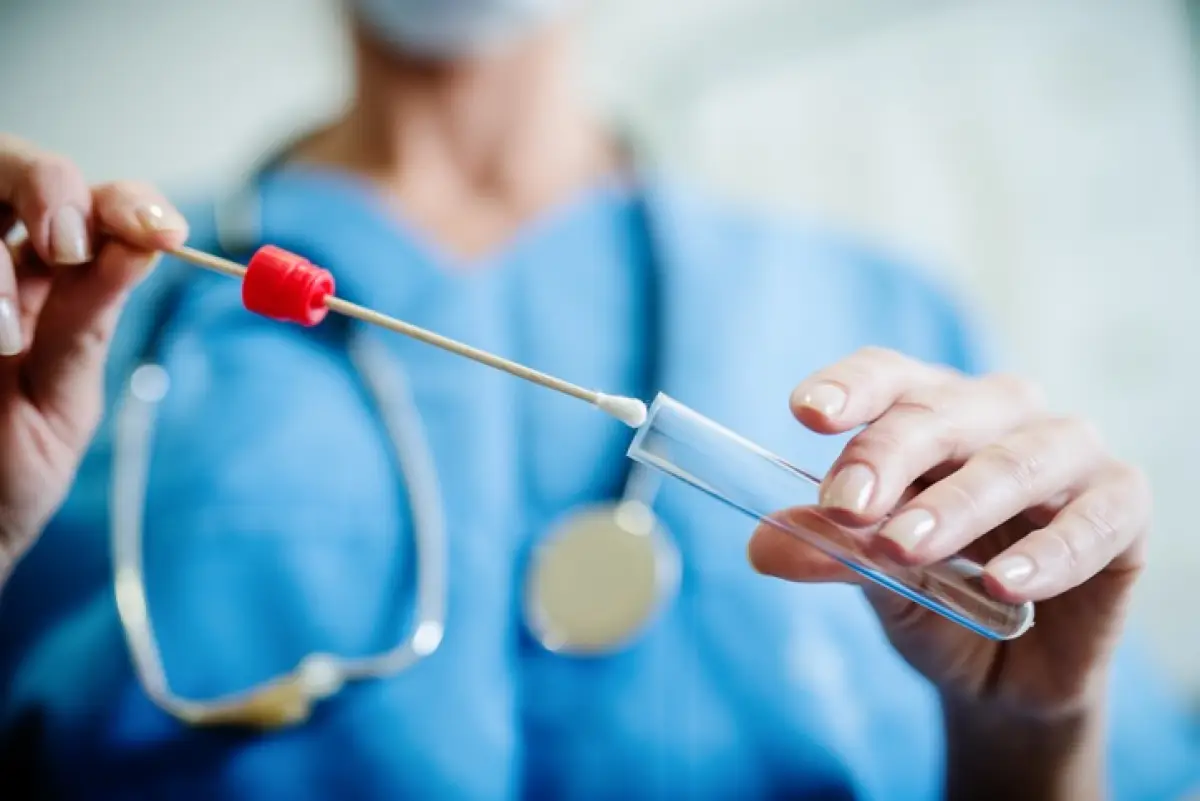 Close up of doctor with sample from sick woman. Selective focus on sample.