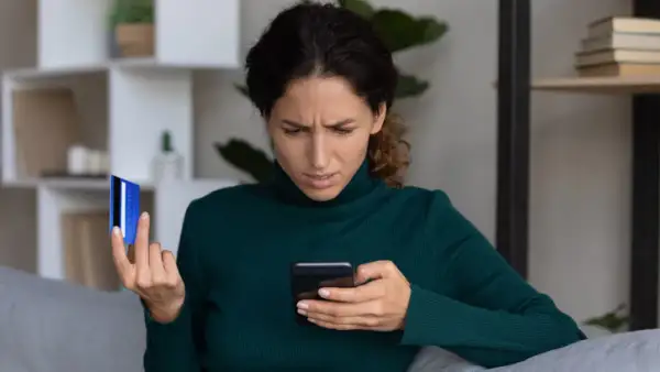 Una persona revisa su teléfono ante una alerta de fraude