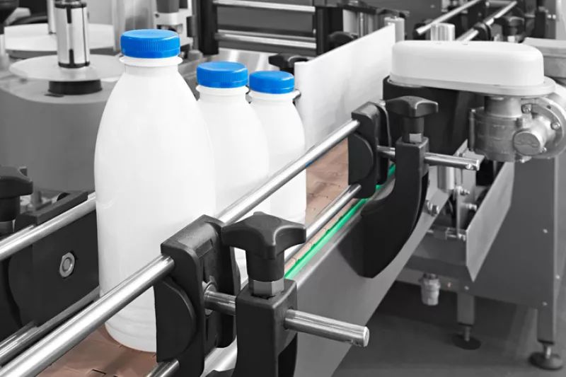 Plastic bottles on conveyor belt ready for pouring milk