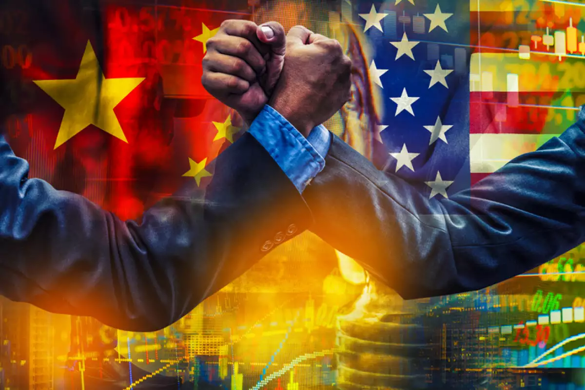 businessman competing in arm wrestling on USA and china flag background