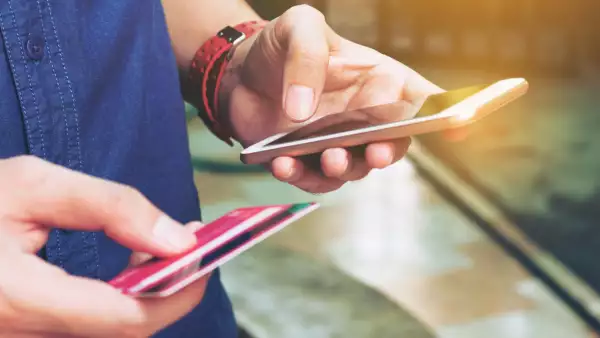 Man use smart phone and holding credit card with shopping