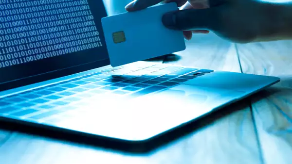 The concept of credit card theft. Hackers with credit cards on laptops use these data for unauthorized shopping. Unauthorized payments from credit card owners. In the hacker's secret office