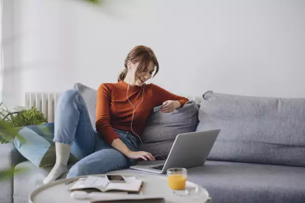 Women in business using a laptop for online shopping while working from home