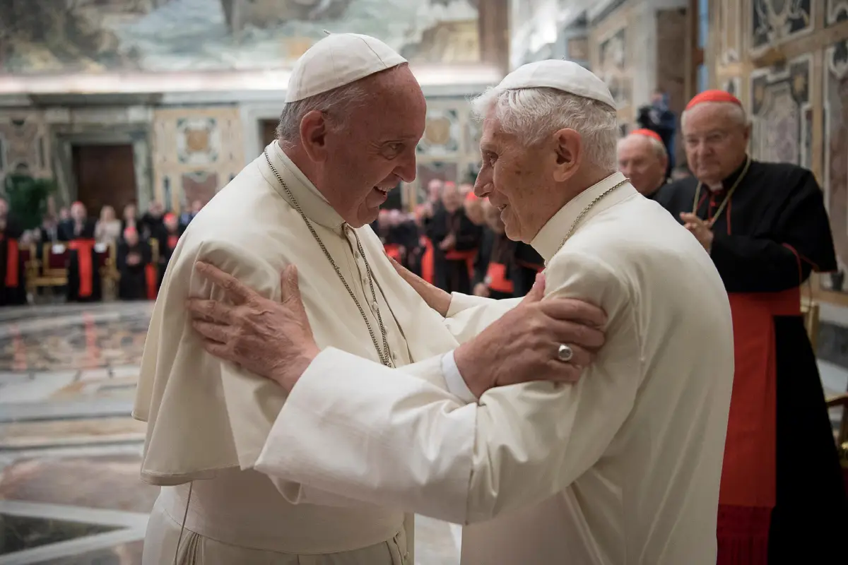 FILE PHOTO: Former pope Benedict is greeted by Pope Francis during a ceremony to mark his 65th anniversary of ordination to the priesthood at the Vatican