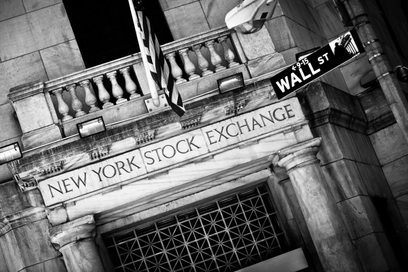 New York Stock Exchange entrance with Wall Street sign