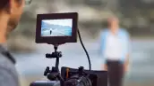 Cropped shot of an unrecognizable man filming outside on his set