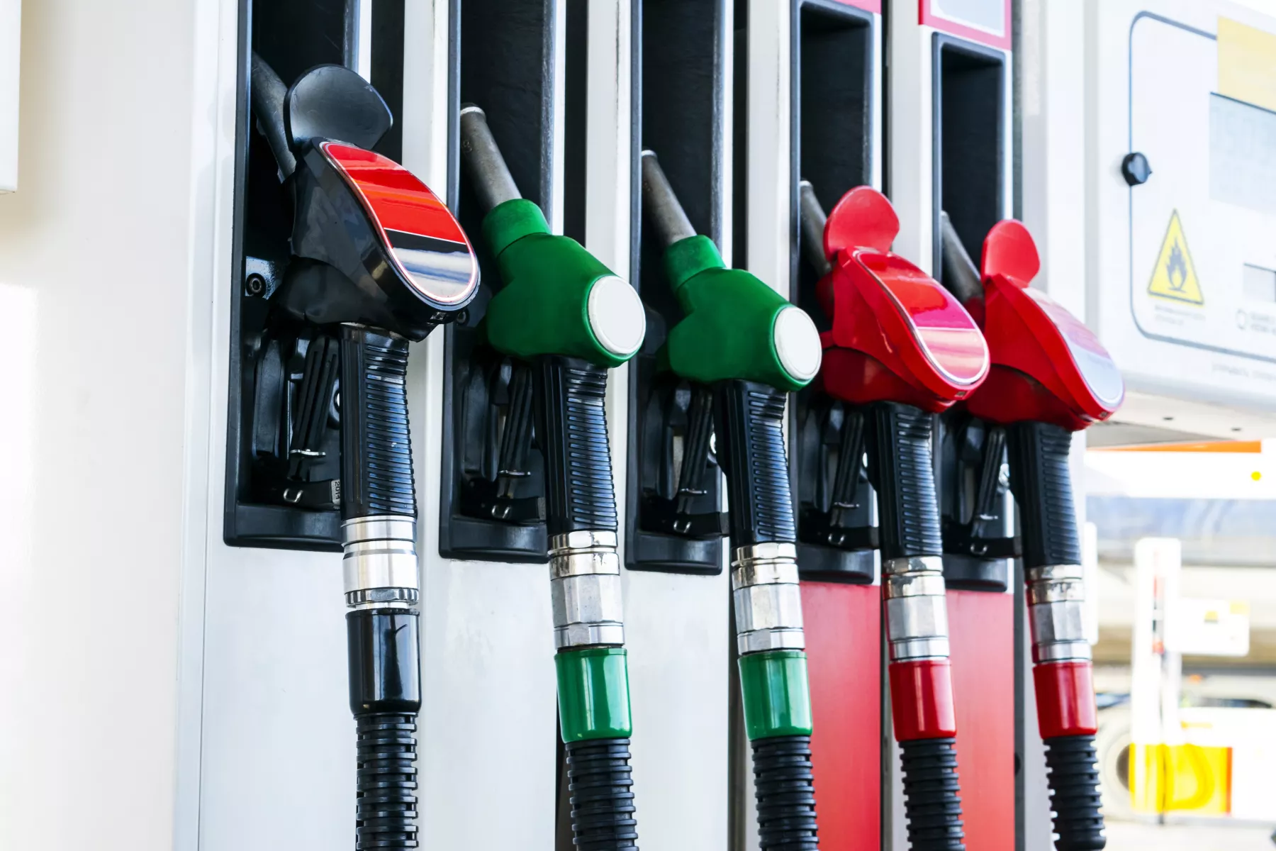 Gasoline and diesel distributor at the gas station. Gas pump nozzles. Petrol filling gun close-up at the gas station. Colorful Petrol pump filling nozzles. Fuel pump