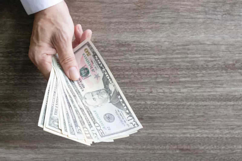 Man holding dollar banknote.young businessman holding money.Business and finances making and saving money concept.