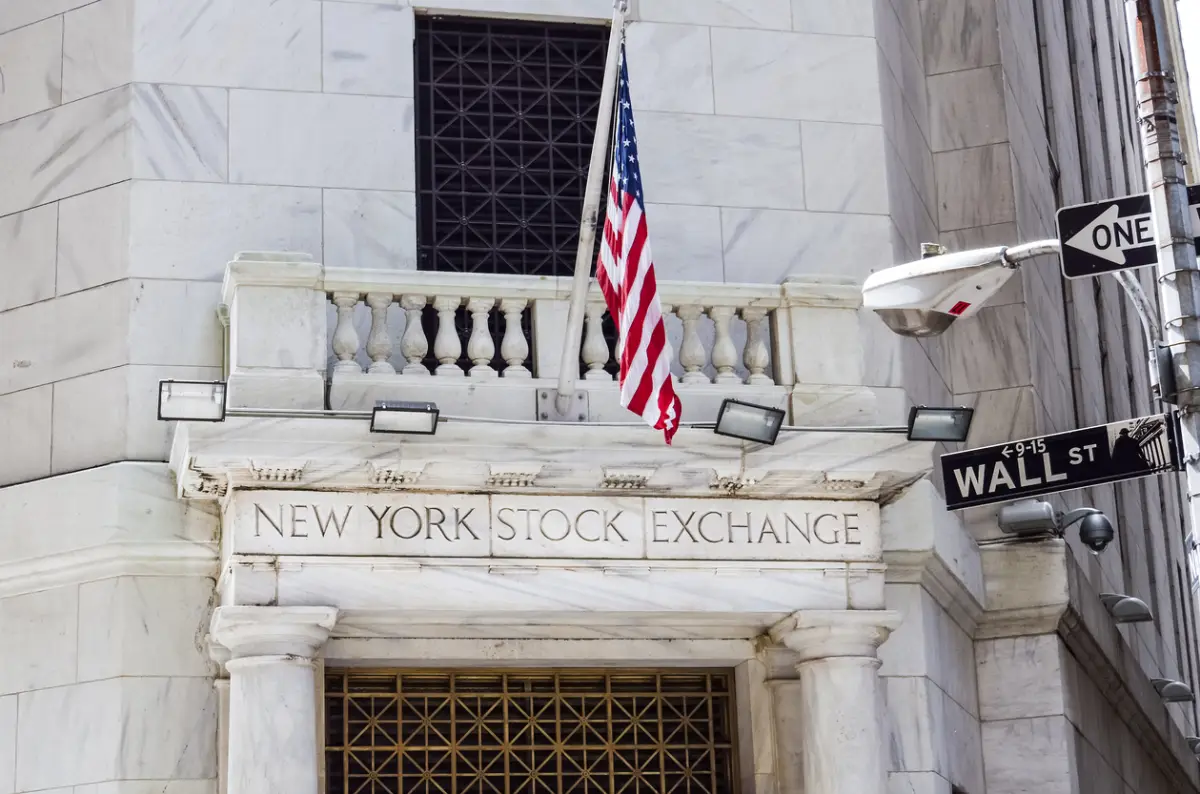 New York Stock Exchange with American flags and Wall street