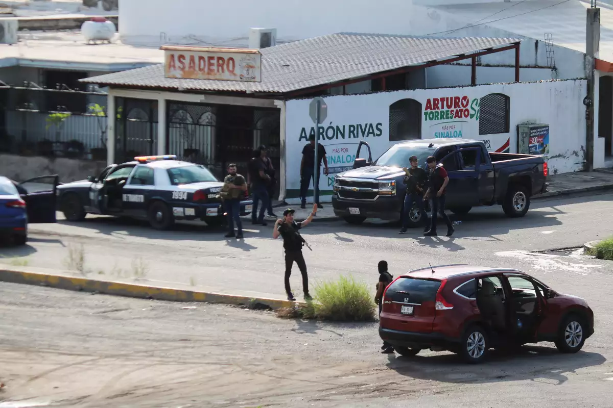 Cartel gunmen are seen on a street during clashes with federal forces following the detention of Ovidio Guzman, son of drug kingpin Joaquin "El Chapo" Guzman, in Culiacan
