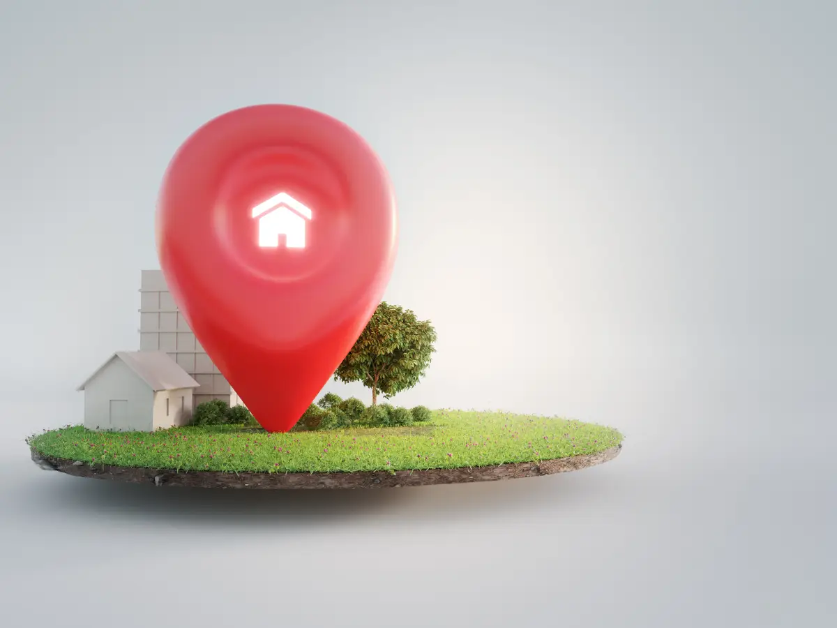 House symbol with location pin icon on earth and green grass in real estate sale or property investment concept.