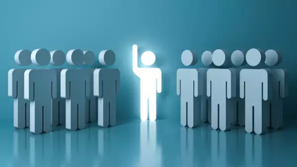 Stand out from the crowd and different concept , One glowing light man raising his hand among other people on light green pastel color background with reflections and shadows