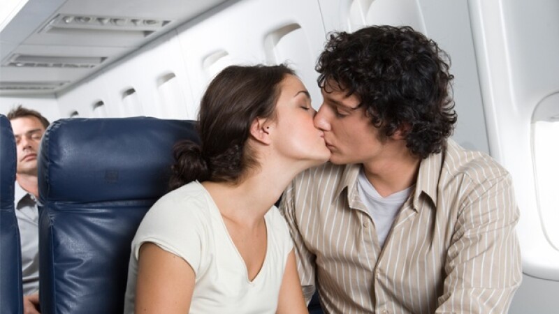 pareja beso avion vuelo