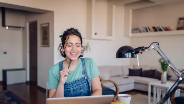 Retrato de una chica usando su computadora portátil en casa