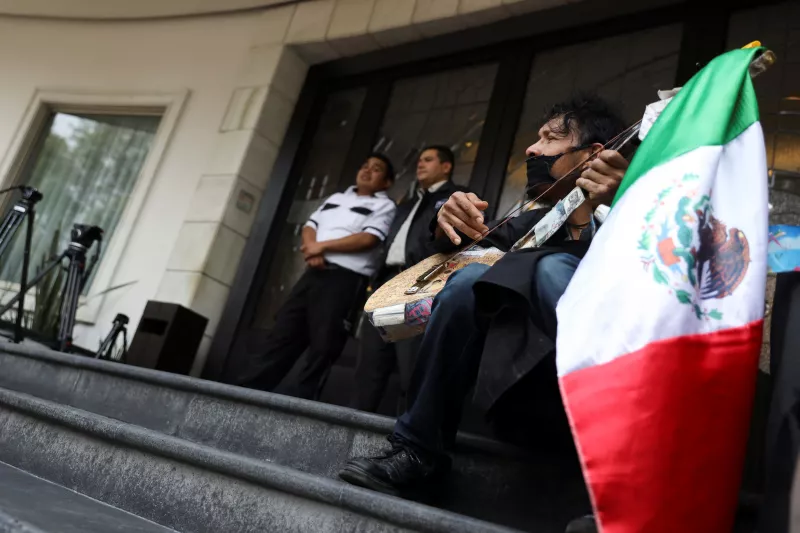 A musician performs outside the funeral home where the remains of actor Javier Lopez are held during his funeral service, in Mexico City