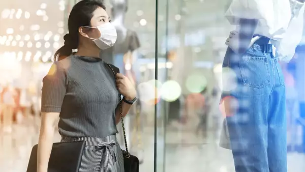 new normal after covid epidemic yound asian female wear face mask protection shopping dress or cloth in boutique shop new lifestyle in department store mall background