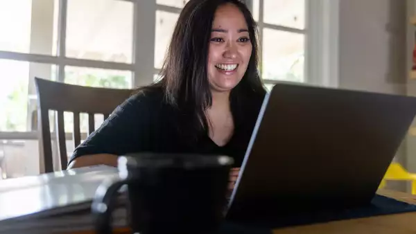 Young Asian Woman listening to Sales Pitch on Video Call