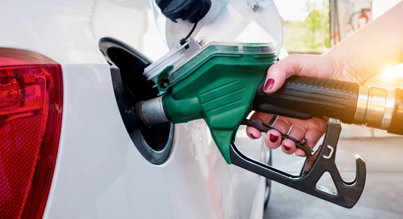 Car refueling on gas station. Woman pumping gasoline oil.
