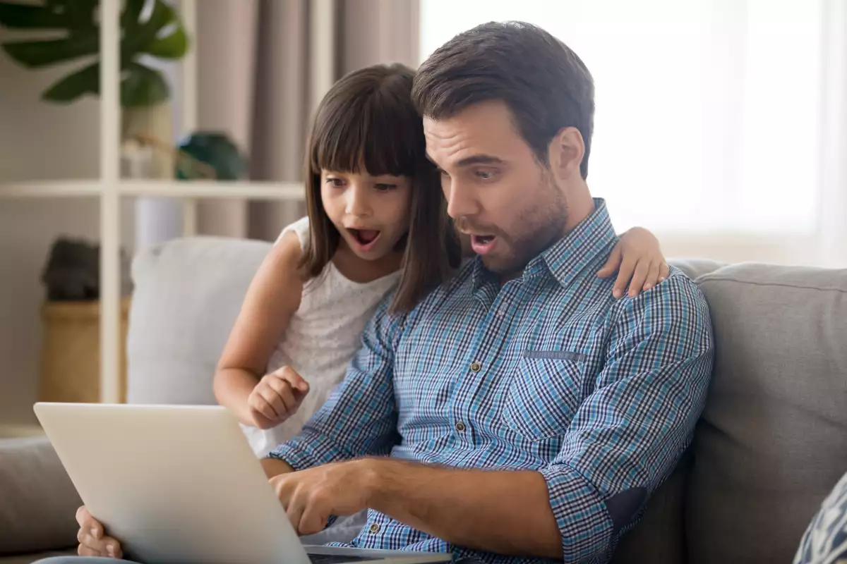 Amazed dad and child surprised with unbelievable online shopping together