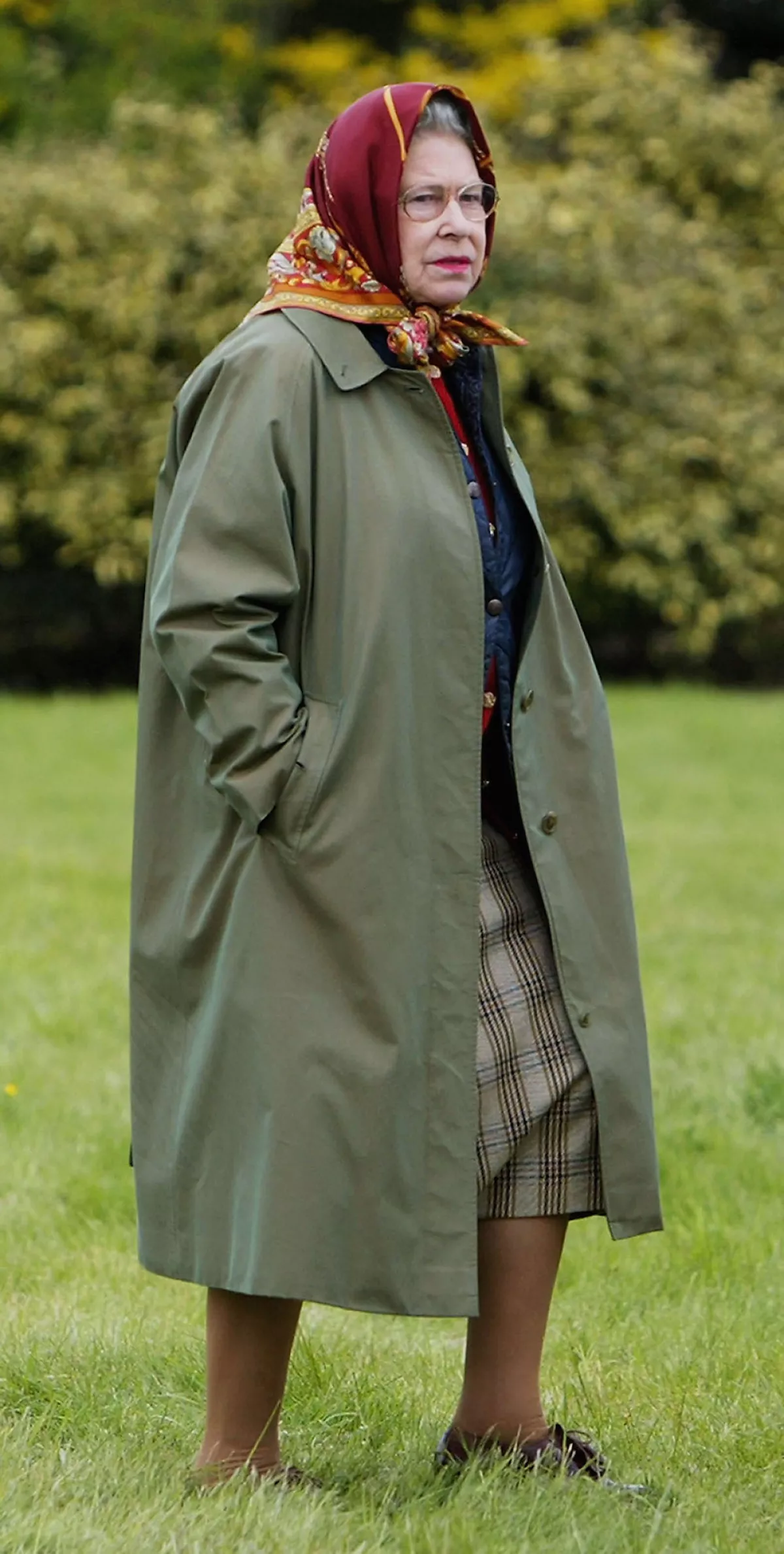 Reina Isabel II con trench coat. 