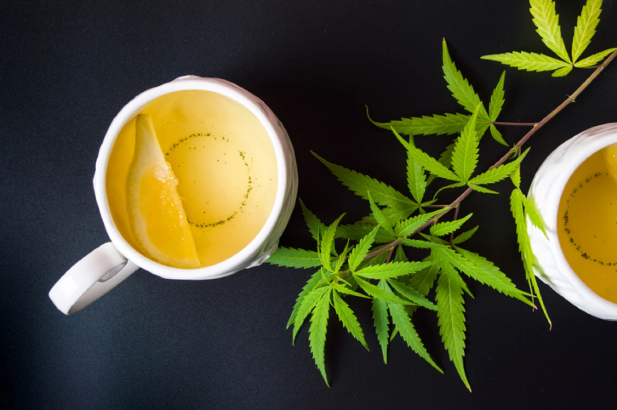 Cannabis tea with marijuana leaves and lemon