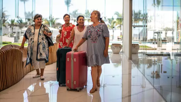 Senior friend arriving at a hotel with their luggage