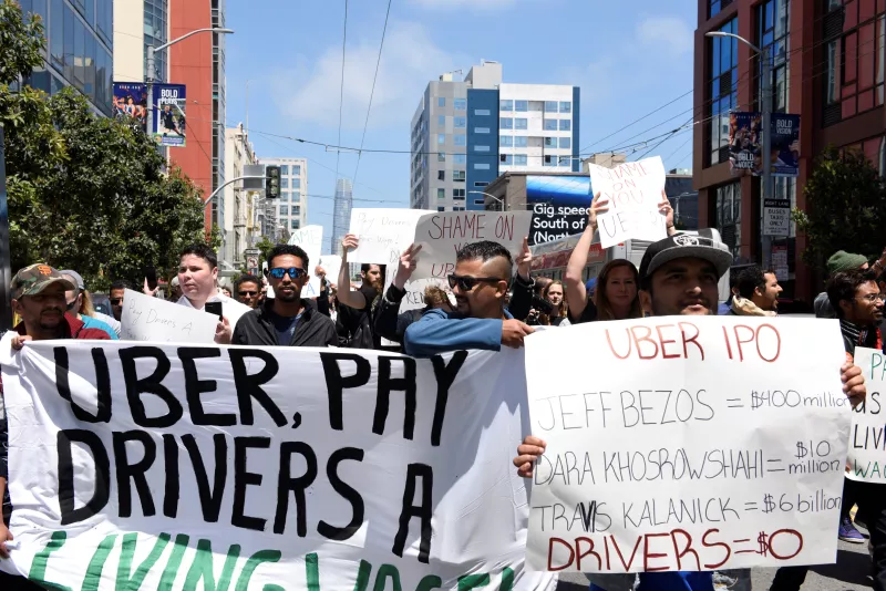 Uber drivers strike against the company's recent 25 percent wage cut outside Uber's head office in San Francisco