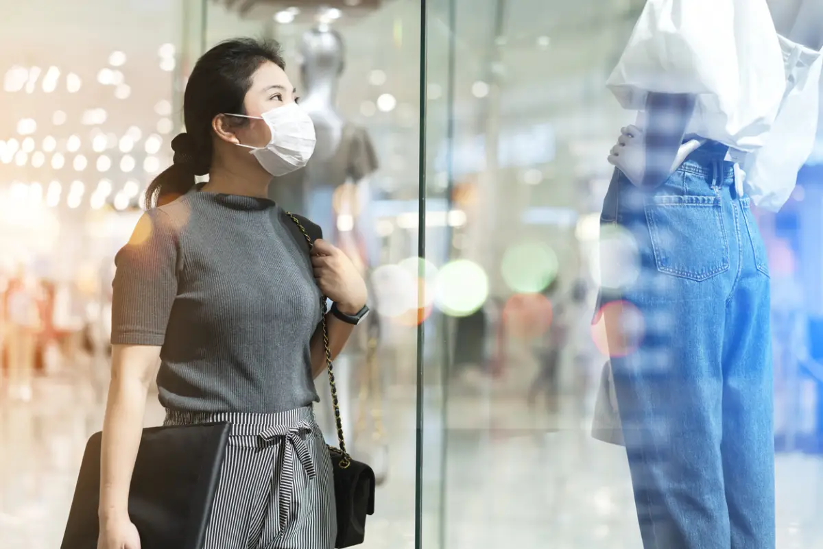 new normal after covid epidemic yound asian female wear face mask protection shopping dress or cloth in boutique shop new lifestyle in department store mall background