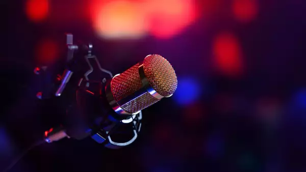studio microphone in neon lights. sound recording equipment