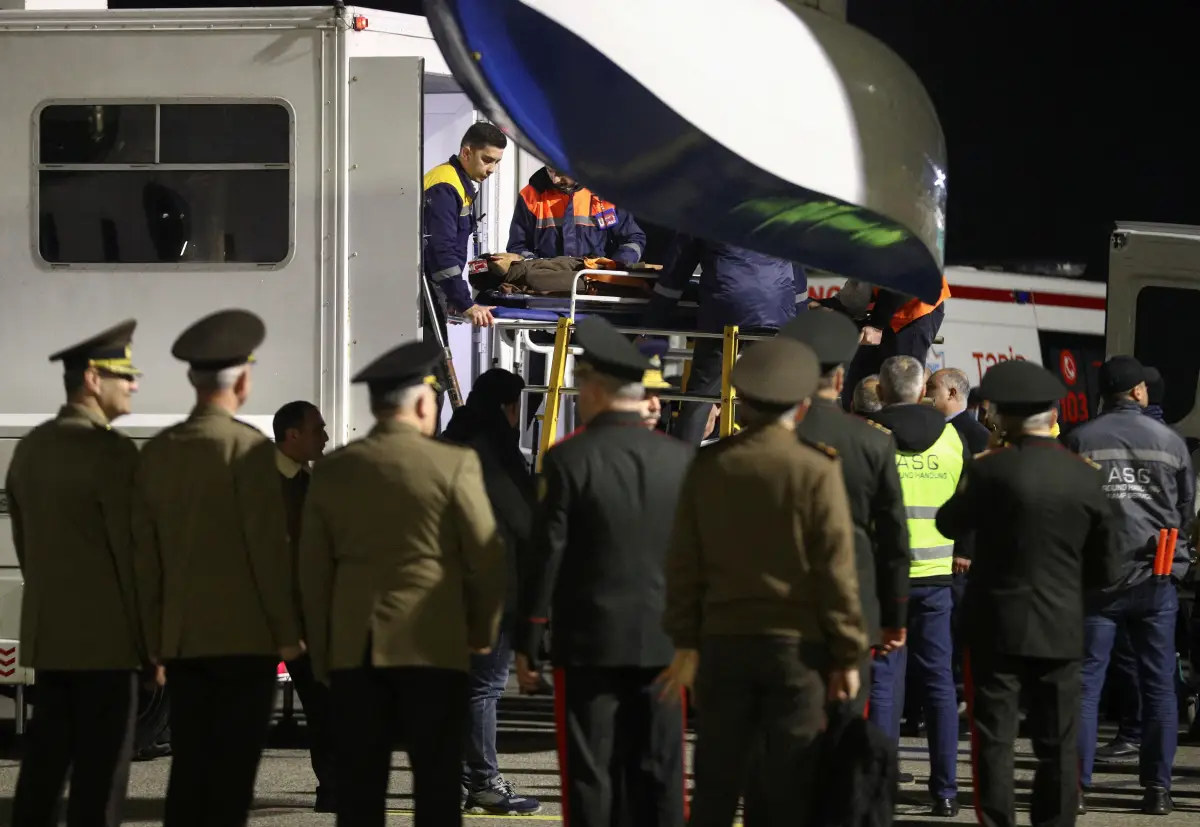 Un pasajero del avión Embraer de Azerbaijan Airlines, que resultó herido en un accidente cerca de la ciudad kazaja de Aktau, es transportado en una camilla a una ambulancia al llegar a un aeropuerto en Bakú, Azerbaiyán, el 26 de diciembre de 2024.