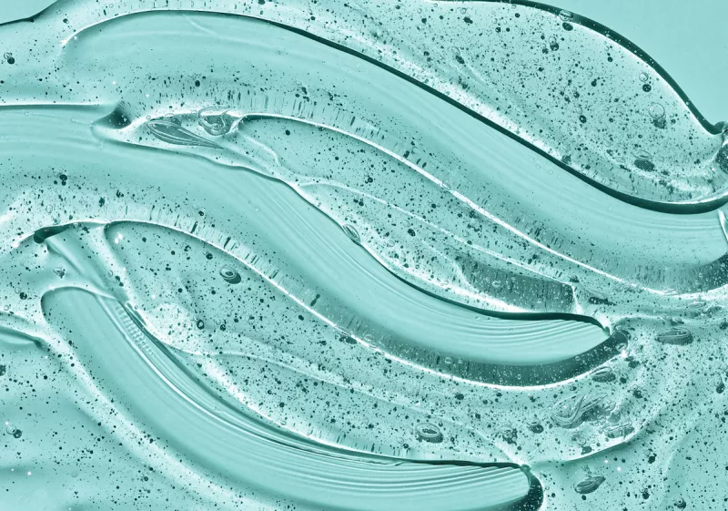 Transparent skin care product.Cosmetic clear liquid cream smudge. Liquid gel cosmetic on blue background.